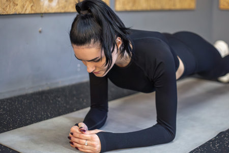 Young woman exercise in gym. Woman and workout with push ups for muscle.