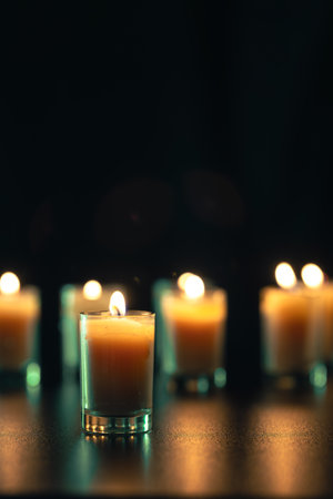 Burning candle on black background with backlight. Memorial Day.の写真素材