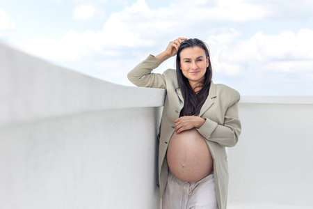 Stylish pregnant woman wearing a jacket. Concept of style and pregnancy.の写真素材