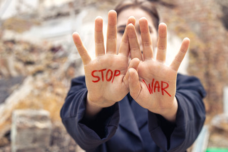 Slogan of peace without war is written on the womans hand in red stop war.の写真素材