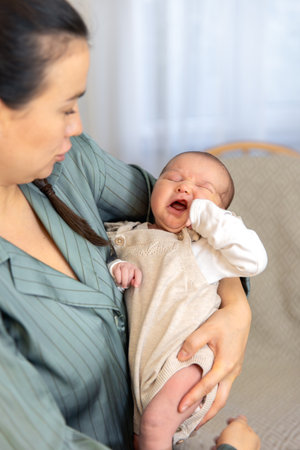 A mother holds a newborn baby in her arms. Newborn baby.の写真素材