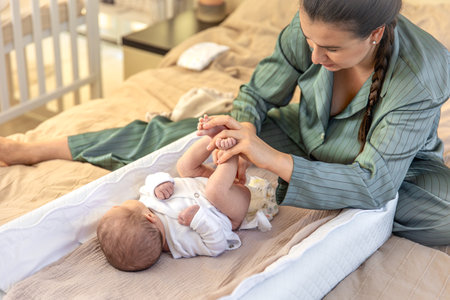 Newborn baby. A mother changes the diapers of a newborn.の写真素材