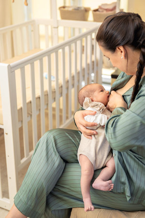 A mother breastfeeds a newborn baby. Motherhood child care concept.の写真素材