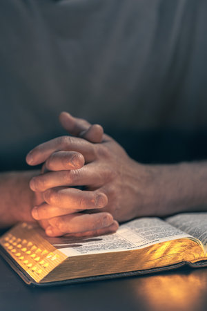 A man reads the Bible. Male hands with Bible close-up.の写真素材
