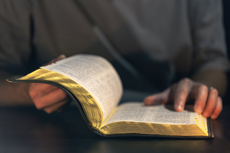 A man reads the Bible. Male hands with Bible close-up.の写真素材