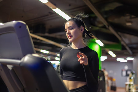 Gym. Fitness woman working gym. Exercises. Running on a treadmill.の写真素材