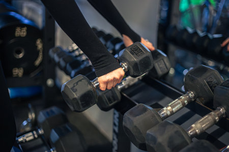 Young woman in the gym. Dumbbells in gym workout. Gym.の写真素材
