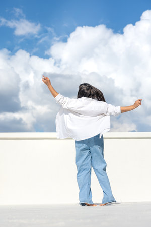 Joyful woman on the background of the sky.の写真素材