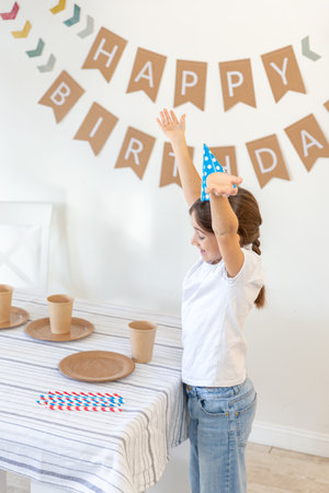 The girl decorates the festive table for her birthday. Birthday concept.の写真素材