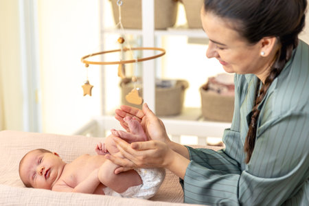 Parent holding in the hands feet of newborn baby. Mom holding baby feet.の写真素材