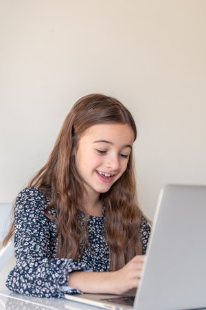 A happy girl is working on a laptop. Girl and laptop. Technology conceptの写真素材