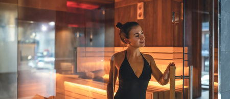 A young woman is relaxing in a sauna. A woman in a sauna.の写真素材