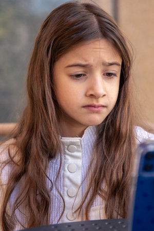 Sad girl with a phone. Sad girl using mobile phone.の写真素材