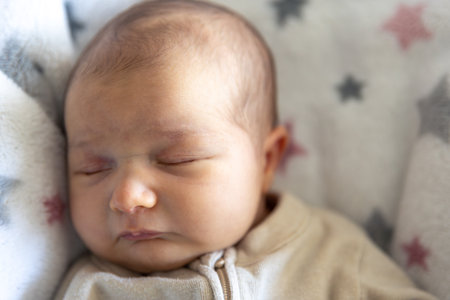 Newborn baby sleep. Girl infant sleep lies in child bed.の写真素材