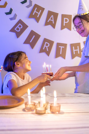 Birthday concept. Happy girl with a birthday cake.の写真素材