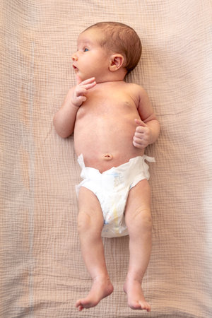 A cute infant wearing a diaper. Newborn baby.の写真素材