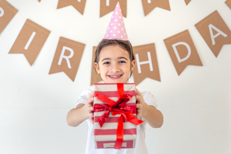 Cute girl with a present on her birthday. Birthday concept.の写真素材