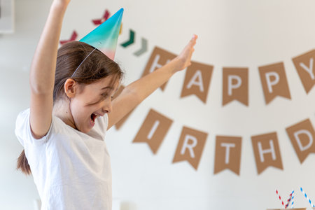 Happy girl celebrating her birthday. Birthday concept. A girl in a festive hat.の写真素材