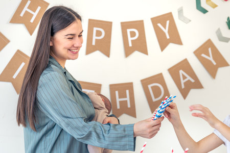 Mother and daughter celebrate a birthday. Birthday party at home.の写真素材