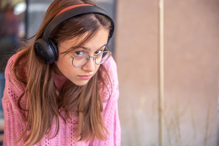Teenage girl in headphones. Emotions concept. Girl in headphones close-up.の写真素材