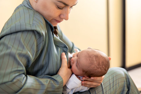 A mother breastfeeds a newborn baby. Motherhood child care concept.