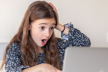 Surprised girl with laptop. Girl and laptop. Technology concept.の写真素材