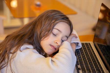 Girl sleeping over laptop.の写真素材