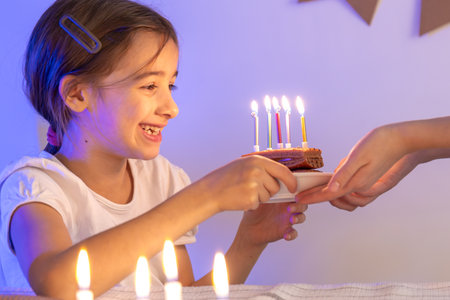 Birthday concept. Happy girl with a birthday cake.の写真素材