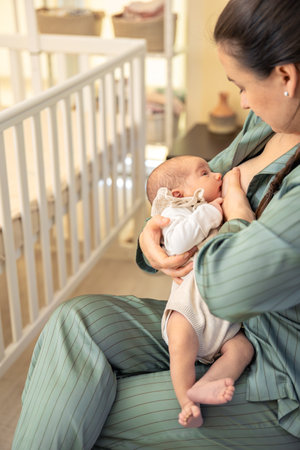 A mother breastfeeds a newborn baby. Motherhood child care concept.の写真素材
