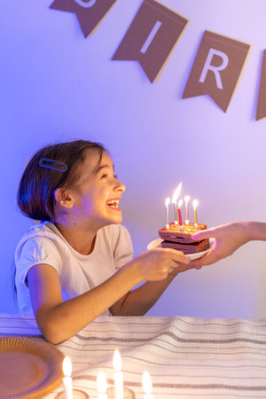 Birthday concept. Happy girl with a birthday cake.の写真素材