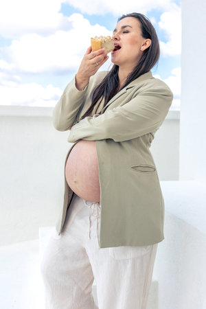 Pregnant woman with a cake in her hands.の写真素材