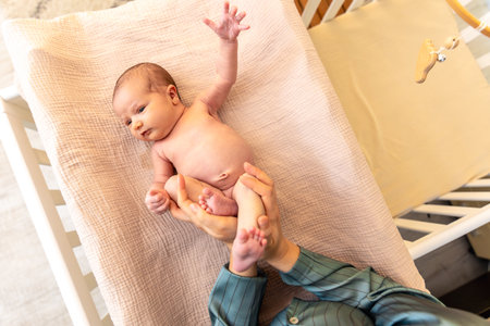Parent holding in the hands feet of newborn baby. Mom holding baby feet.の写真素材
