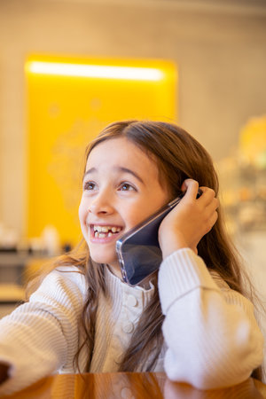 A girl with a phone. The girl is talking on the phone.の写真素材