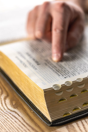 Close-up of the Bible. Holy book Bible. A man reads the Bible.