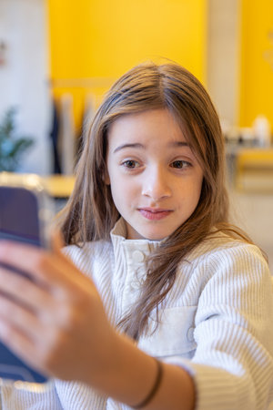 The girl takes a selfie. A girl with a phone.の写真素材