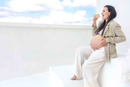 Pregnant woman with a cake in her hands.