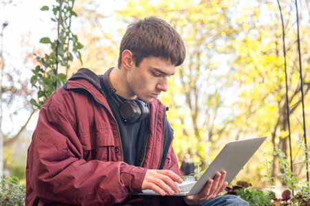 A student studies using a laptop. Male student studying online.の写真素材