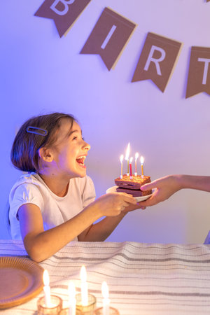 Birthday concept. Happy girl with a birthday cake.の写真素材