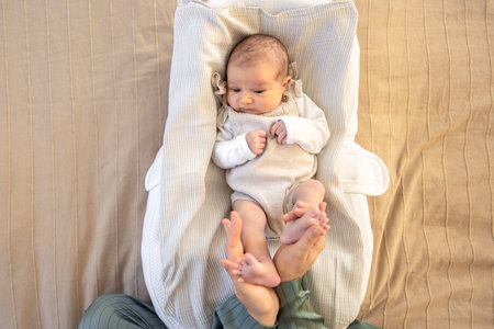Parent holding in the hands feet of newborn baby. Mom holding baby feet.の写真素材
