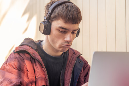 A student studies using a laptop. Male student studying online.の写真素材