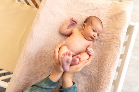 Parent holding in the hands feet of newborn baby. Mom holding baby feet.の写真素材