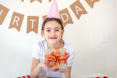 Cute girl with a present on her birthday. Birthday concept.の写真素材