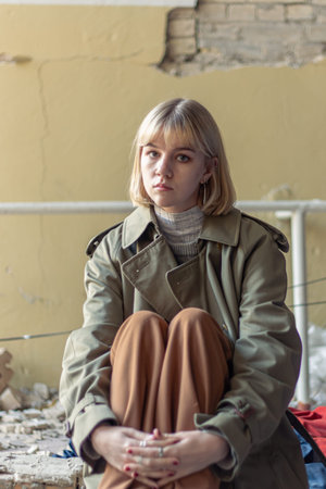 A woman next to a house destroyed by the war. War in Ukraine.の写真素材