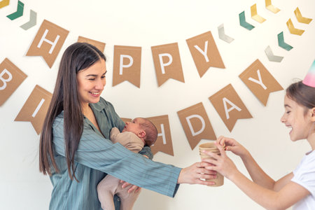 Mother and daughter celebrate a birthday. Birthday party at home.の写真素材