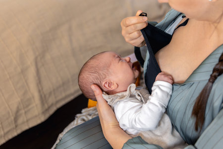 A mother breastfeeds a newborn baby. Motherhood child care concept.の写真素材