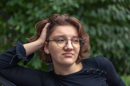 Pensive young woman close-up. Emotion concept.の写真素材