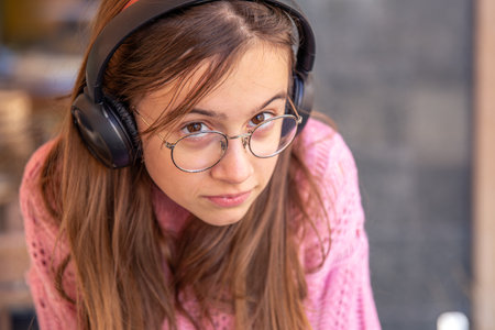 Teenage girl in headphones. Emotions concept. Girl in headphones close-up.の写真素材