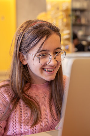 An interested teenage girl studies in an online school.の写真素材