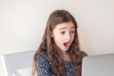 Surprised girl with laptop. Girl and laptop. Technology concept.の写真素材