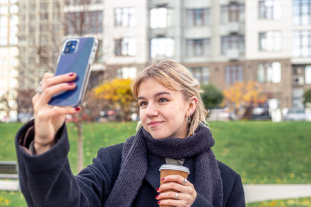 Woman in the city taking a selfie for memory. A beautiful woman in the city.の写真素材